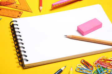 Pencil and eraser on spiral blank notebook.