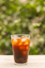 Iced coffee black coffee isolated on green
