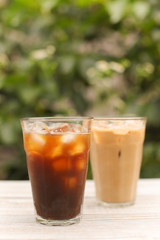 Iced coffee black coffee and latte isolated on green
