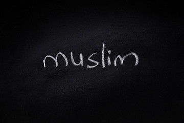 Fototapeta premium Handwritten muslim word written on blackboard