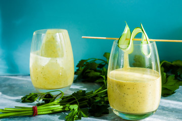 Healthy smoothie with mango, ananas passion fruits and chia seeds blended and   poured on a glass over a white background. Detox, diet, healthy, vegetarian food concept with copy space.