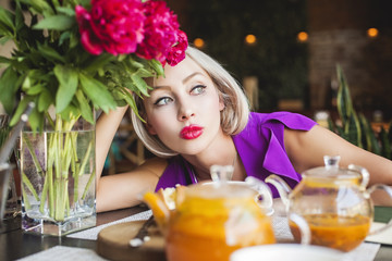 Blonde woman sitting in restaurant