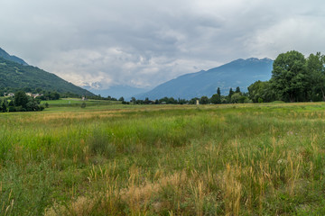 Mountain landscape with green Garden and blue and rose sky