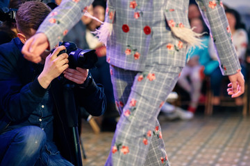 Professional photographer working at fashion week on presentation of new collection