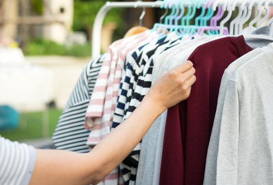 Female choosing shirt in shop