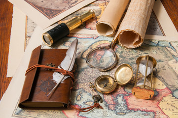 Planning a trip: quill pen, old papers and maps with vintage items