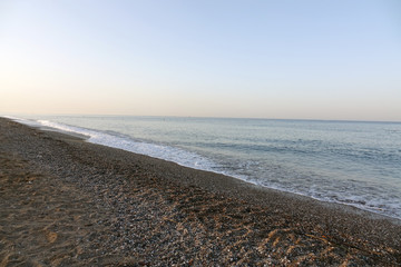 Pebble beach and blue sky on background