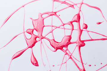 Nail polish on a white background in the form of strips and drops