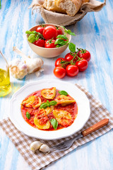 Delicious pasta - ravioli in tomato sauce with basil