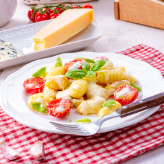 delicious gnocchi with gorgonzola cream sauce and cherry tomatoes