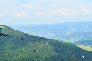 People are carrying by cableway in the Carpathian mountains