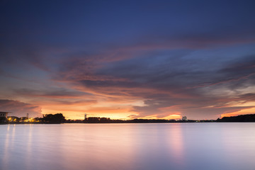 Colorful surface of waiving water on dam at sunset time with color full sky 