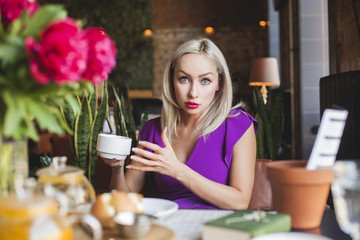 Pretty Young Woman chatting in Cafe