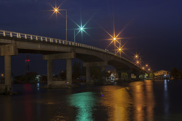 Stone bridge cross along river at night time colorful located in east of thailand - Powered by Adobe