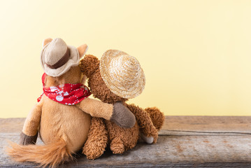Friendship, teddy bear holding plush horse in its arms, toned vintage