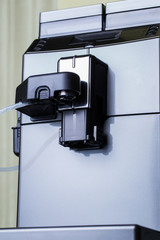 Automatic gray coffee machine close-up stands in the kitchen