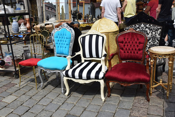 old retro armchairs and pitchers chairs at the stall of antiquities