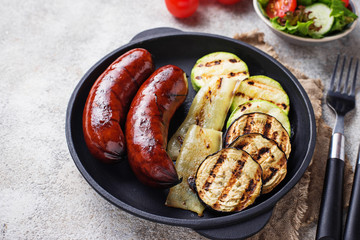 Grilled pork sausages and vegetables