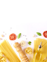 Food and drink concept - various uncooked pasta with ingredients for cooking