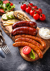 Assortment of grilled sausages and vegetables