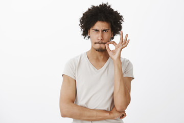 I never say word. Intense and serious attractive hispanic guy with moustache and beard, pursing...