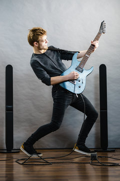 Young man playing electric guitar