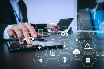 businessman working with smart phone and digital tablet and laptop computer in modern office with glass reflected view