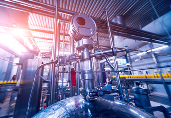 Modern interior of a brewery. Barrels and pipes. Factory interior.
