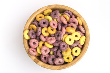 wooden bowl full of cereals in the form of colored circles
