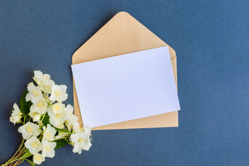 Mockup white greeting card and envelope with white jasmine flowers