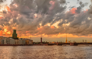 Fototapeta premium Peter and Paul fortress across the Neva river, St. Petersburg, Russia. Dramatic sunset