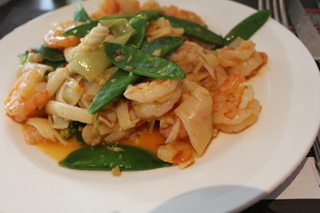 a plate with fried shrimps and vegetables for dinner