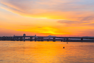 Obraz na płótnie Canvas scenery sunrise above Sarasin bridge. fishing boats parking on the Sarasin beach. Sarasin bridge linking the province of Phang Nga and Phuket.