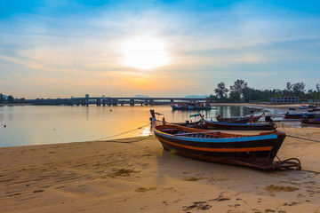 Fototapeta na wymiar scenery sunrise above Sarasin bridge. fishing boats parking on the Sarasin beach. Sarasin bridge linking the province of Phang Nga and Phuket.