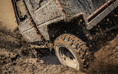 Jeep car splashing in muddy terrain