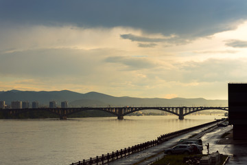 Communal bridge is a automobile and pedestrian bridge across the Yenisei river in Krasnoyarsk, Russia. The embankment on the river bank Yenisei.