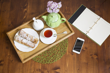 Afternoon tea concept: Cup of herbal linden tea, apple pie on white background. Flat lay