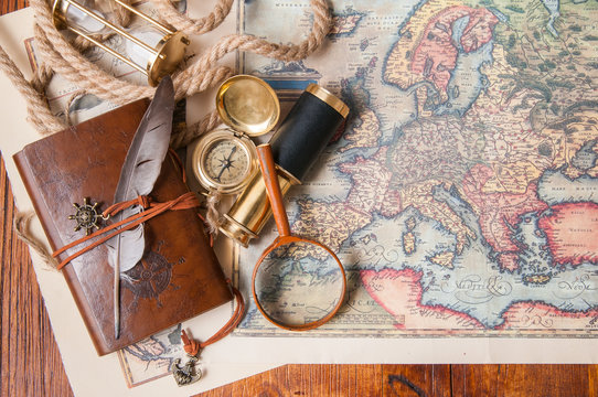 Planning a trip: quill pen, old papers and maps with vintage items