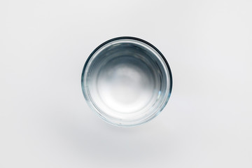 glass with water on a white background top view