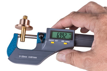 Human hand holding a digital micrometer close-up. Machinist when measuring a bronze and brass metallic part by the precise gauging device with a green display. Isolated on white background.