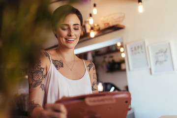 Woman entrepreneur at the billing counter of her restaurant