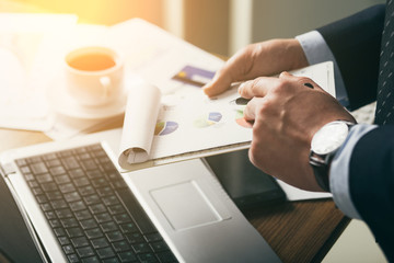 young businessman in office with smartphone tablet at workplace