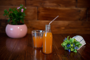 Fresh juice in bottle on wooden table