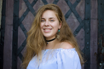 Fototapeta premium Young smiling girl with curly hair