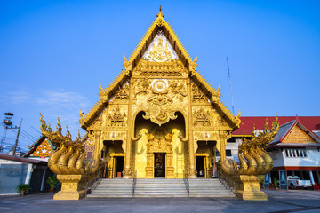 A gold color roof of Buddha temple under clear sky