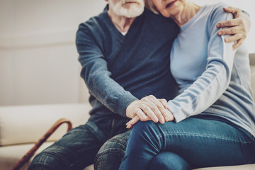 Eternal love. Close up of hands of nice elderly people being held together while expressing their...