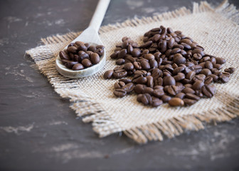 coffee beans background with wooden spoon selective focus