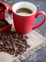 Vintage red coffee grinder, red cup, with coffee beans