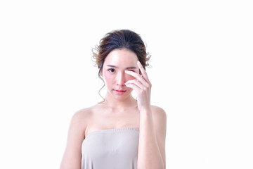 Fototapeta premium The concept of healthy beauty woman. Beautiful women keep healthy. Beautiful women take care of skin health. Beautiful women are thinking about beauty. Beautiful Asian girl is pointing fingers.