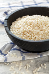 Round white rice in a wooden bowl.